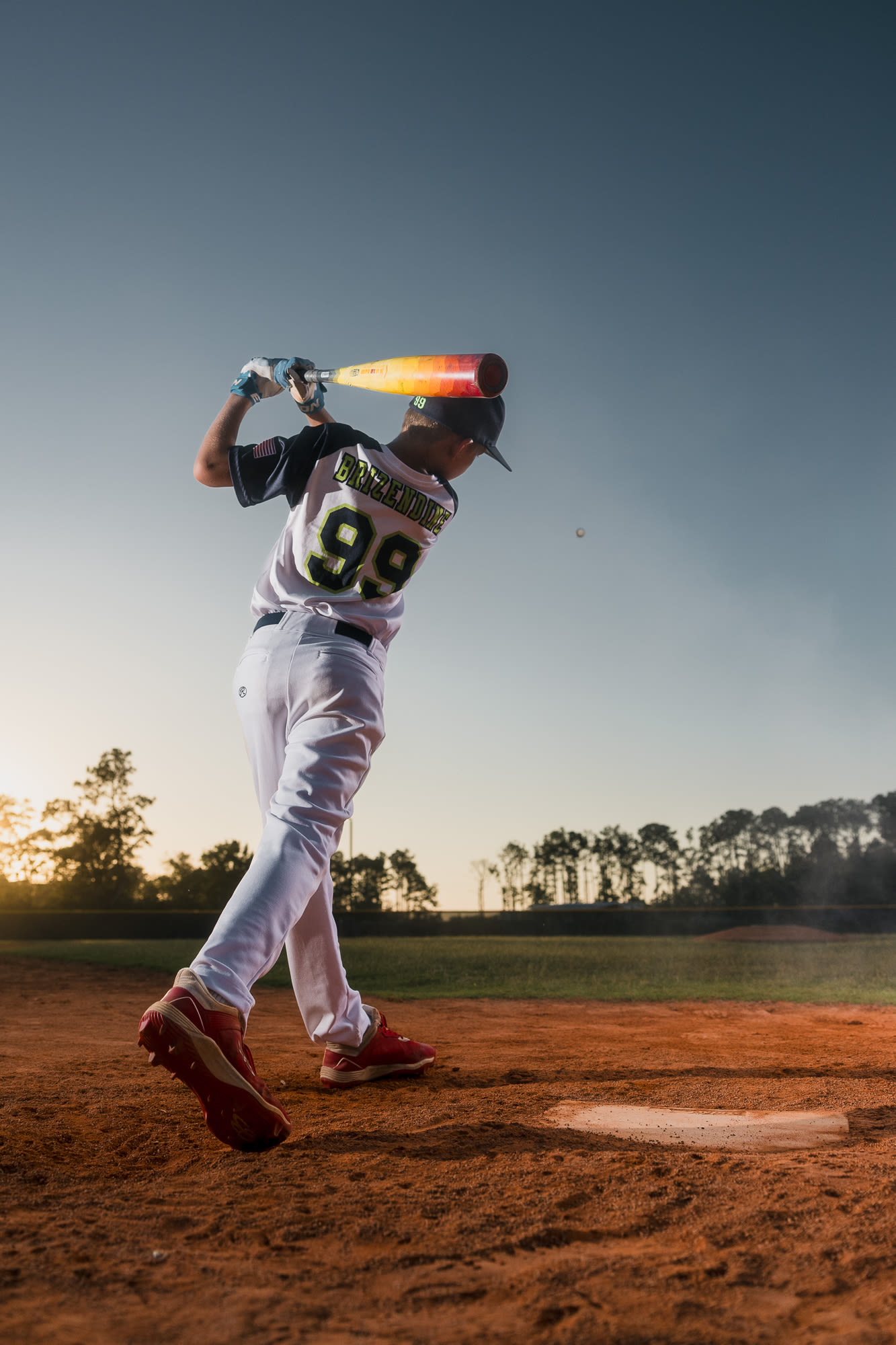 Full-body sports portrait with strong shadows.