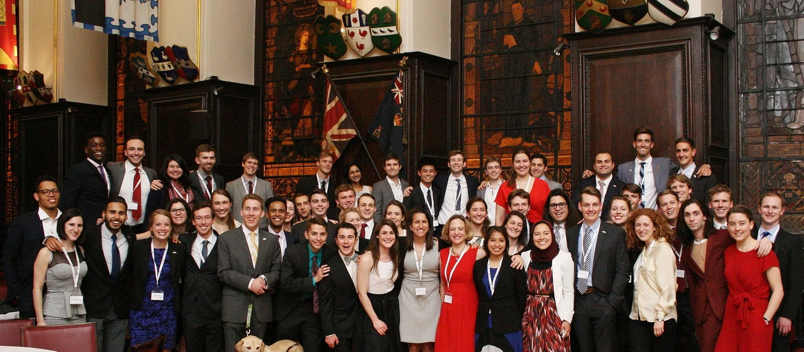 Diverse group of Marshall Scholars celebrating in a historic UK university setting