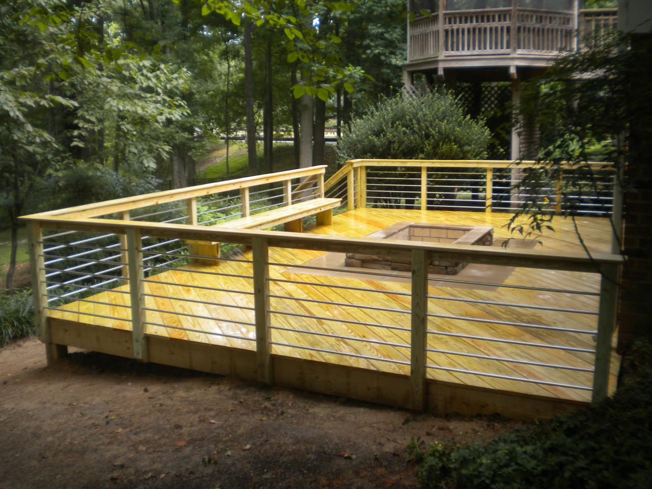 Custom wood deck with built-in fire pit in the center
