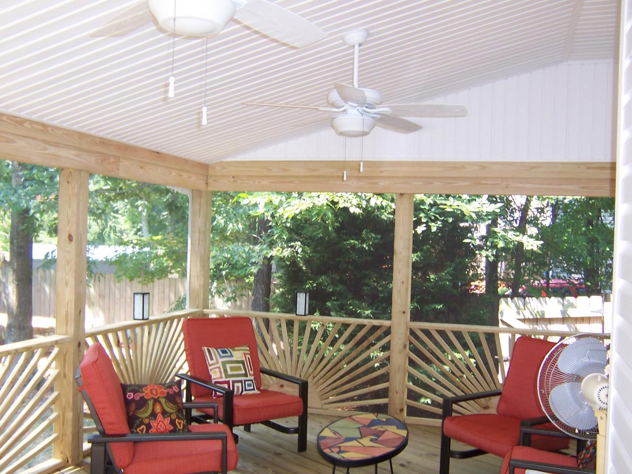 Inside of a screened in porch with artistic wood accents