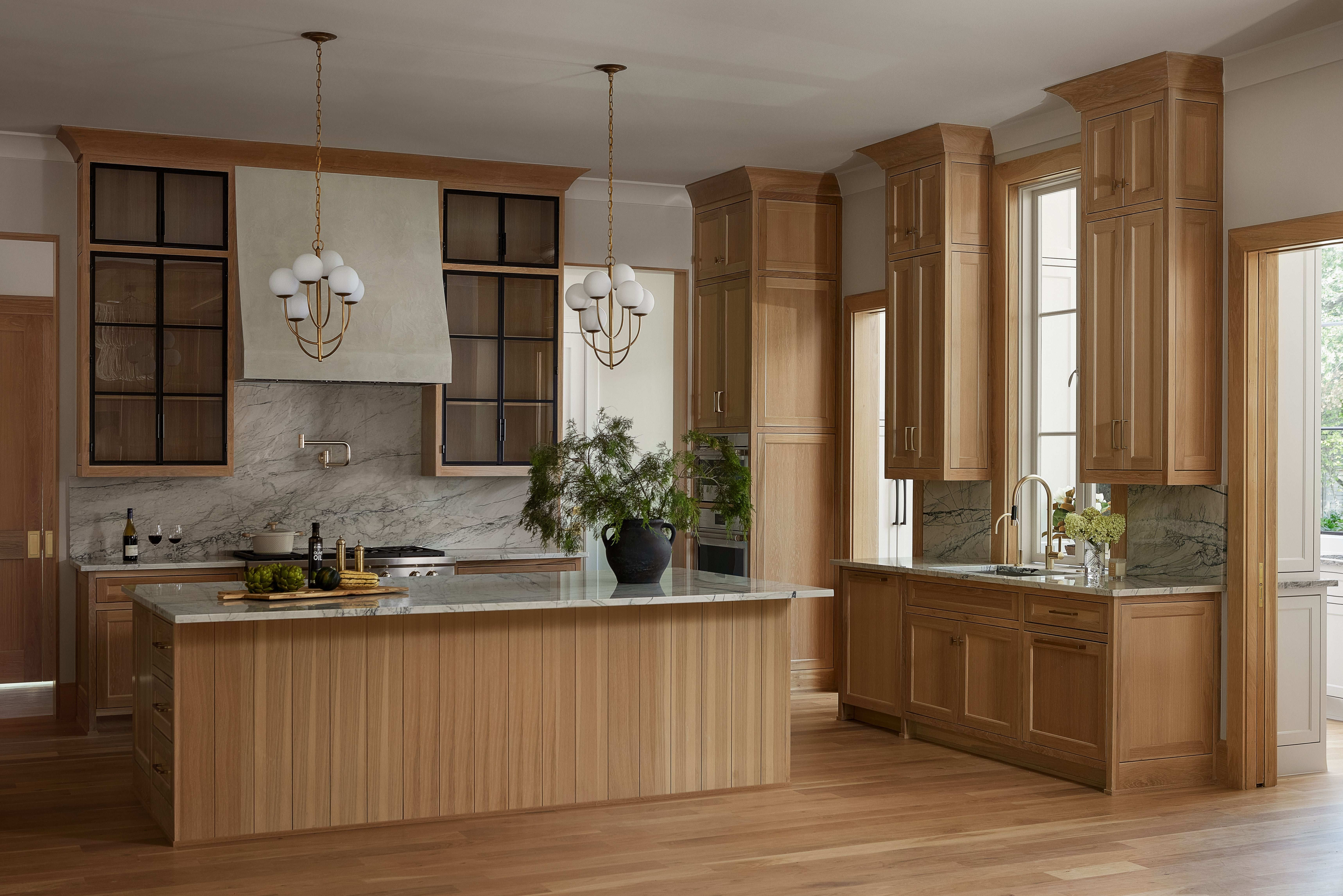 Elegant hallway with high ceilings and arched doorways in a luxury custom home.