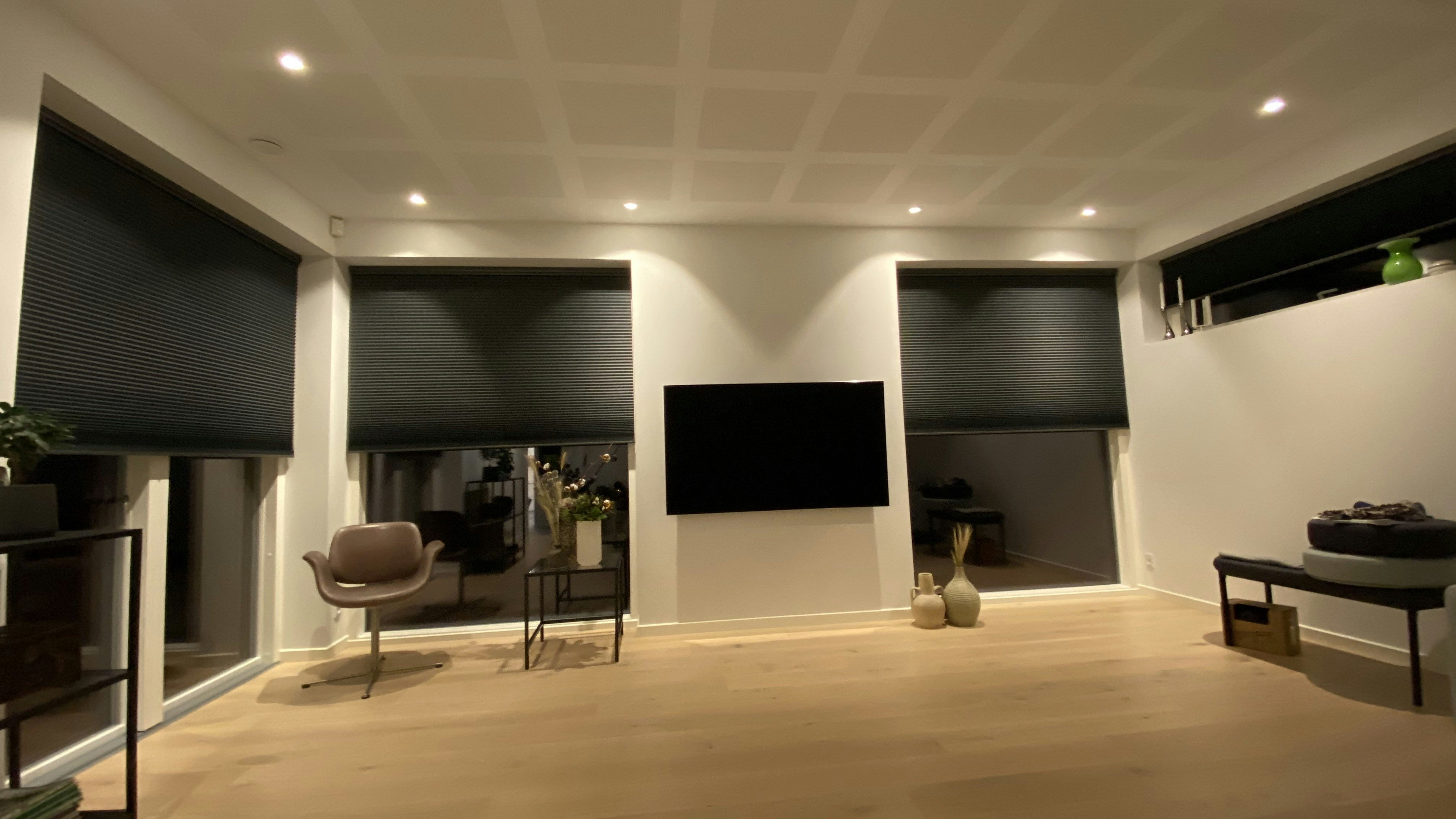 Modern living room with white roller blinds and minimalist furniture