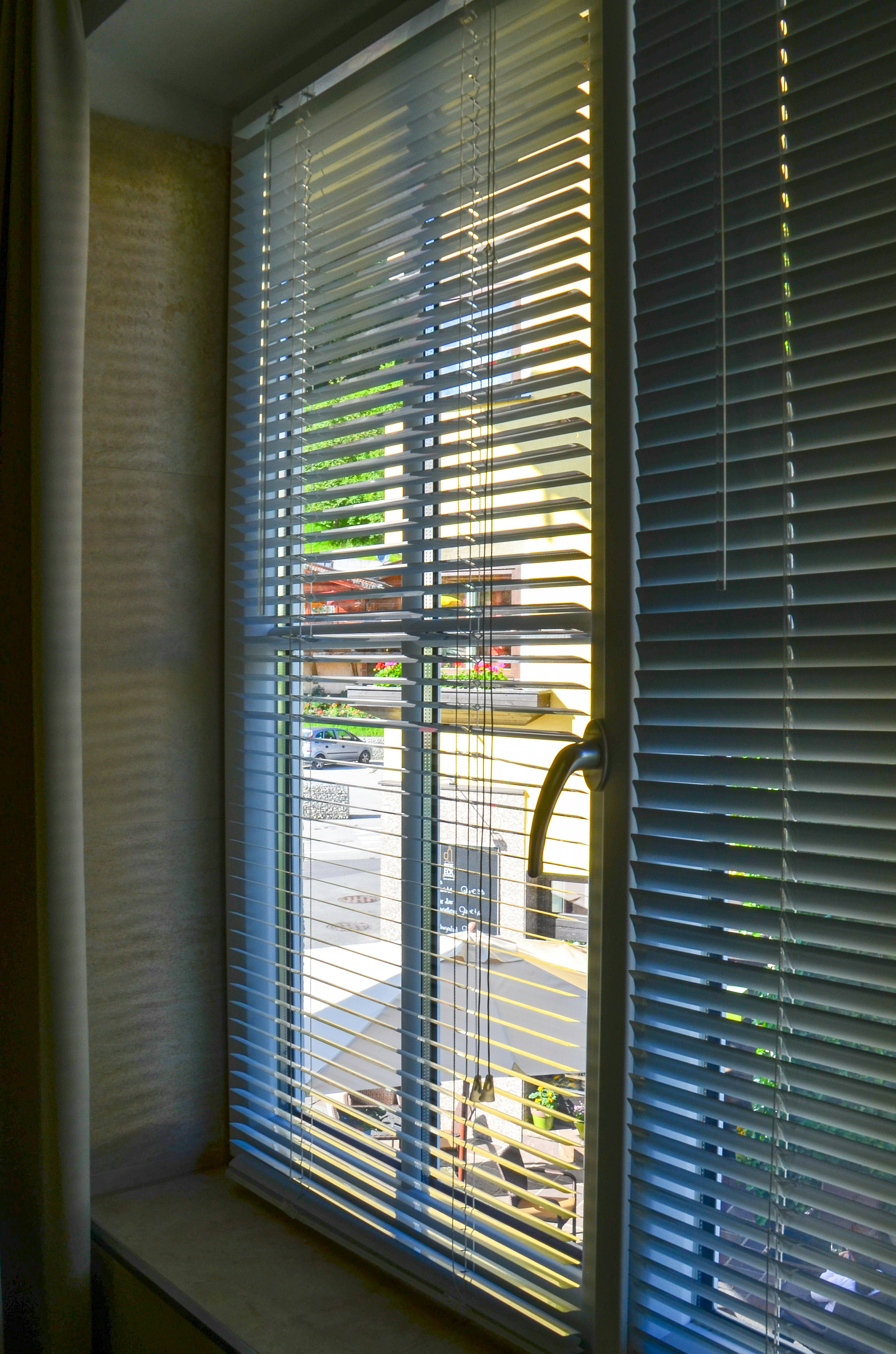 Outdoor patio with weather-resistant blinds for sun protection