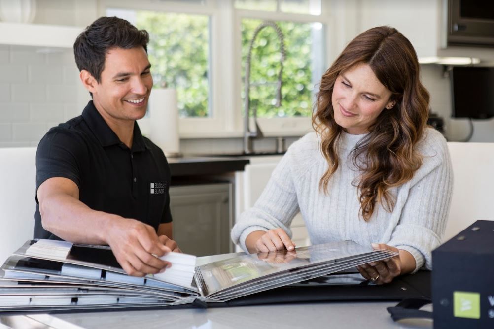 Bright modern living room with roller blinds filtering natural sunlight