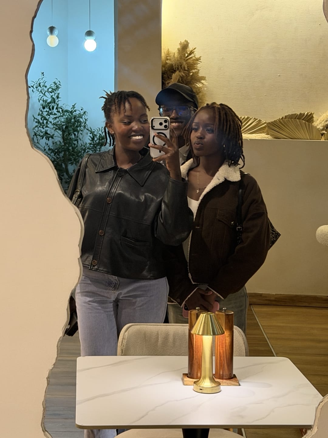 Charity, Emmy and Dave taking a mirror selfie at Artisan Blend Kilimani
