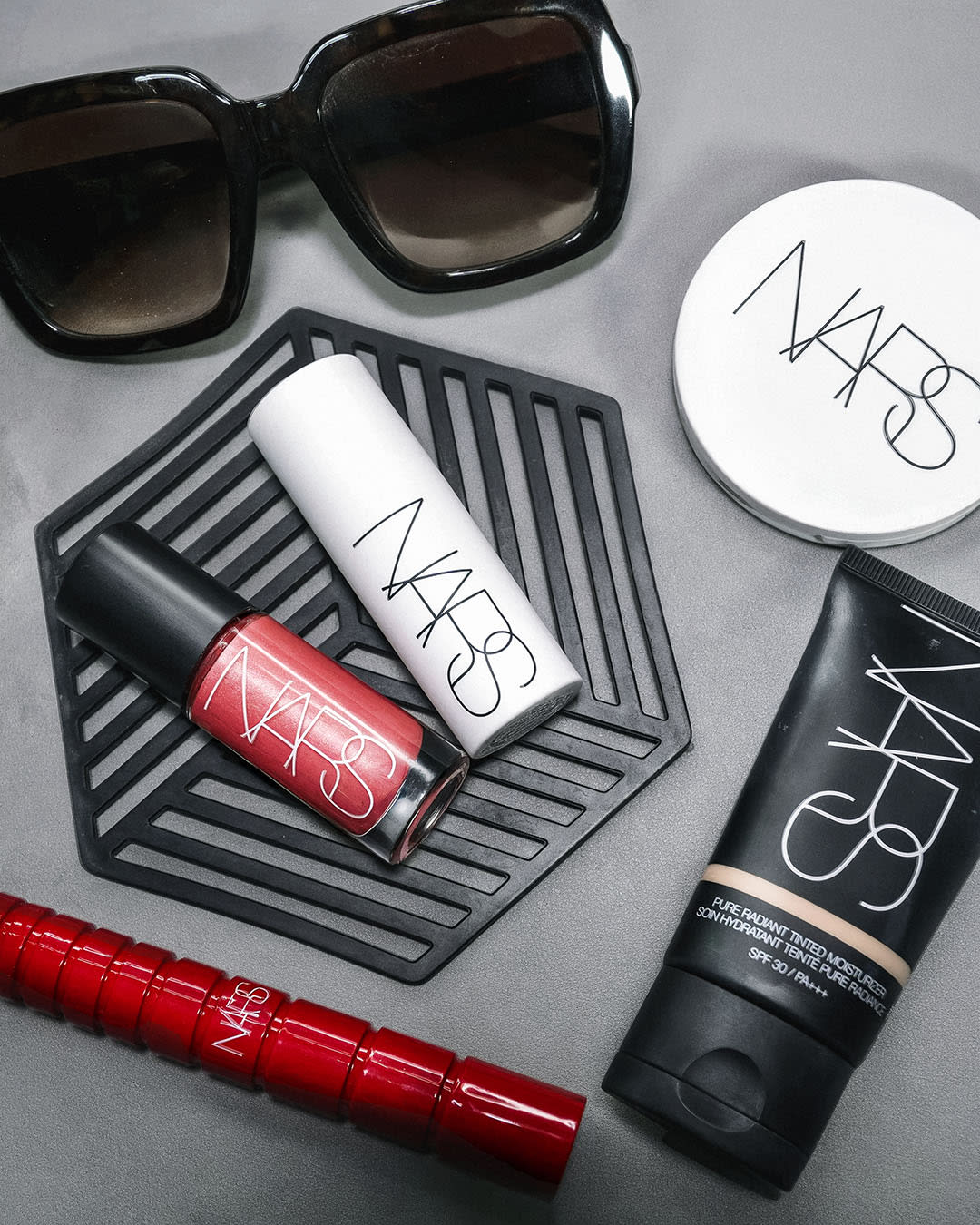 A flatlay of NARS makeup products