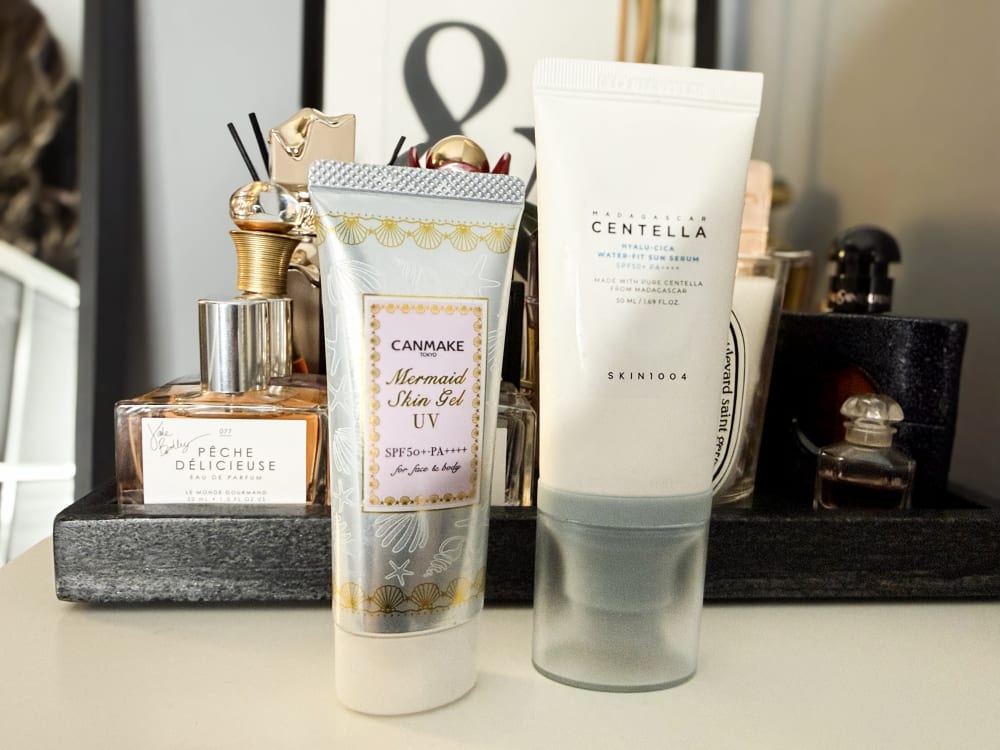 Canmake Mermaid Skin Gel UV and SKIN1004 Madagascar Centella Hyalu-Cica Water-Fit Sun Serum standing on my dressing table, the two sunscreens from this list I still own