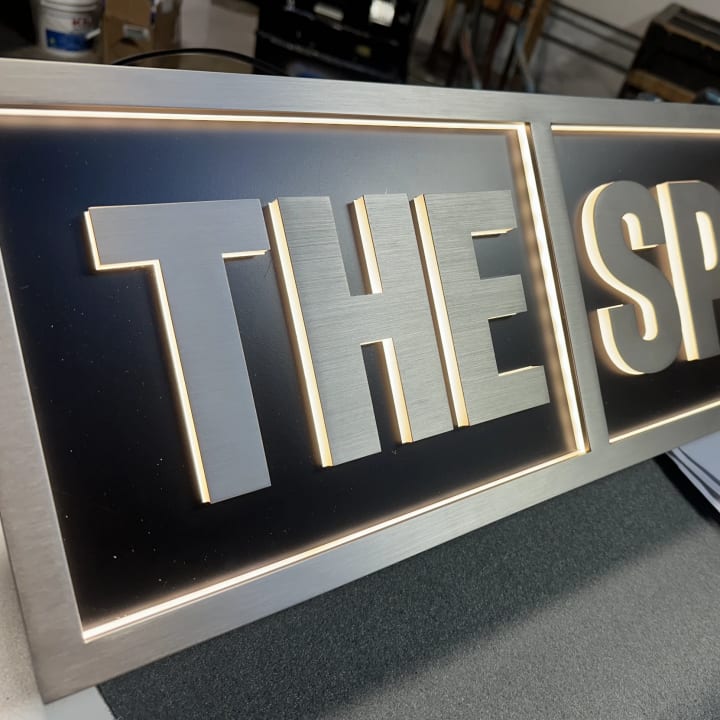 Halo Lit Channel Letters Brushed Metal Sign Closeup, custom signage project in the San Francisco Bay Area.