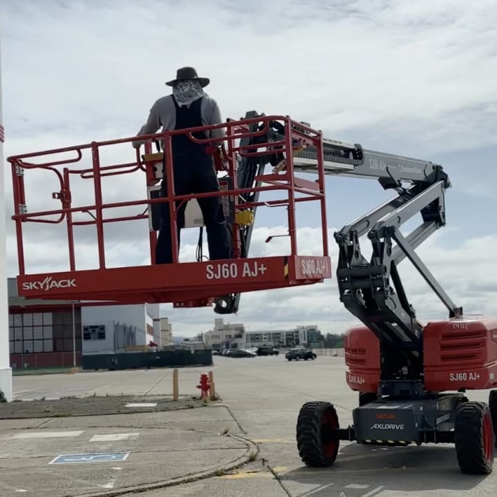 Boom Lift Sign Installation Skyjack Crew, custom signage project in the San Francisco Bay Area.
