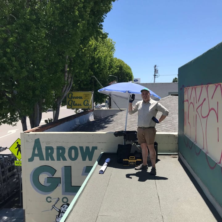 Worker participates in a graffiti abatement project for Aeroglass company in El Cerrito, demonstrating commitment to community and property aesthetics