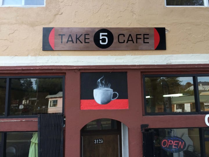 Local Berkeley cafe enhances its ambiance with a 3D black walnut wood sign, exemplifying artisanal sign craftsmanship in the community