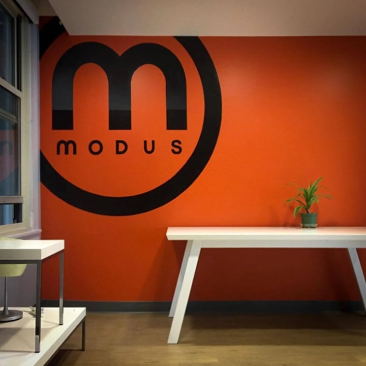 Downtown San Francisco's MODUS cell phone company features engaging entryway office signage, symbolizing innovation and connectivity in the Bay Area