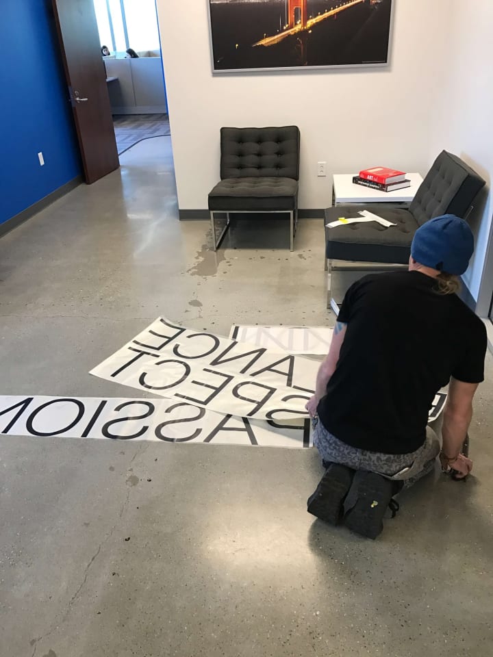 Further progress on the vinyl letter installation at a Silicon Valley tech firm, showcasing meticulous attention to detail and brand enhancement