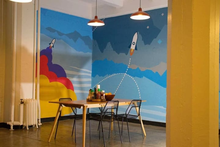 A dynamic rocketship decorative element enlivens the cafeteria/kitchen area in a downtown San Francisco office, infusing the space with creativity and fun