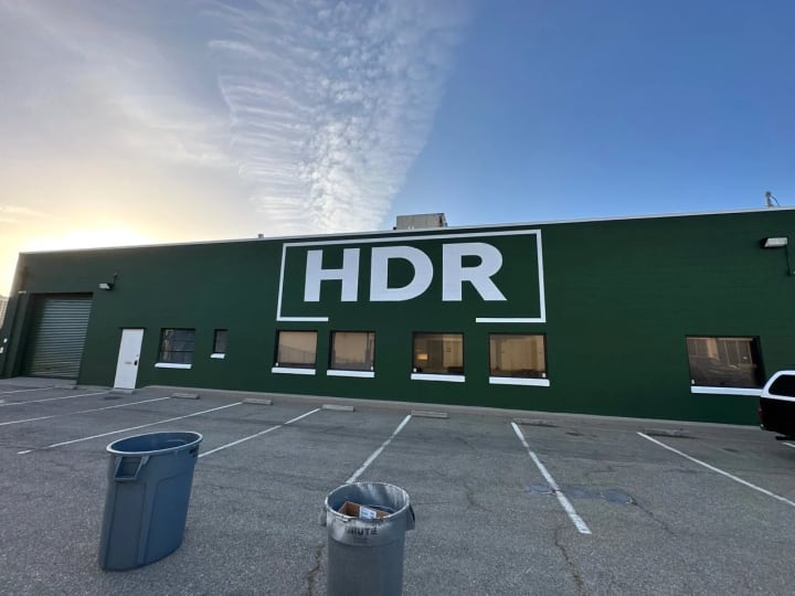 Large HDR construction company logo mural painted on a building in Emeryville, showcasing an impressive 20x40 feet outdoor business signage.