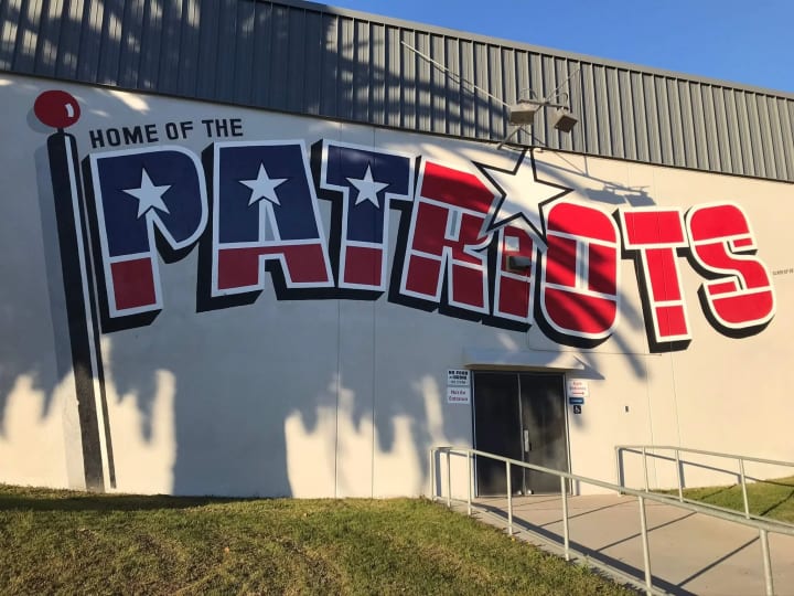 View of a high school campus building prominently featuring its signage, symbolizing educational identity and community pride