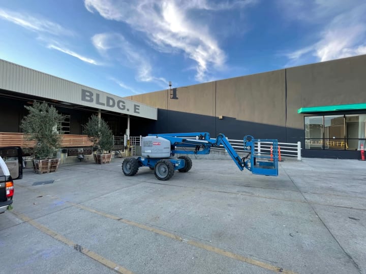 Oakland scene features a lift aiding in sign installation, illustrating the dynamic process and expertise in local sign making