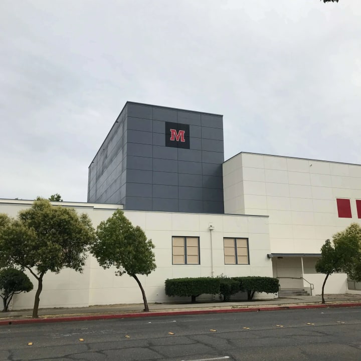 Modesto High School's building showcases their logo painted 60 feet high, highlighting skilled sign making for educational institutions
