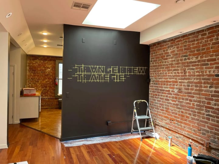 Downtown San Francisco think tank office lobby undergoes precise measurements for a 3D sign installation, showcasing meticulous sign making skill