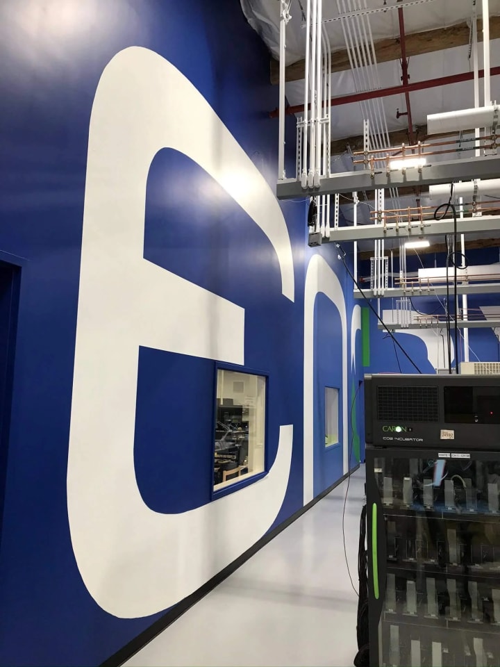 Inside a Silicon Valley battery company's R&D lab, custom 40-foot letters demonstrate the facility's grandeur and innovative spirit