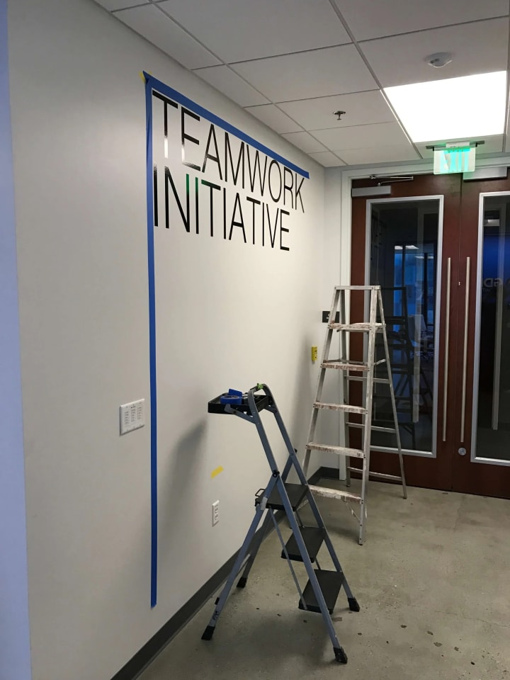 A prominent Silicon Valley tech company undergoes vinyl letter installation, illustrating cutting-edge branding and sign making expertise