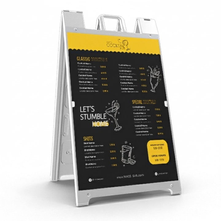 Concept image of a black and yellow cocktail menu in a white A-frame