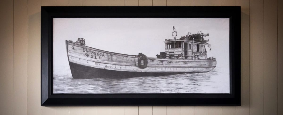 Artist painting a detailed boat mural for a commercial interior
