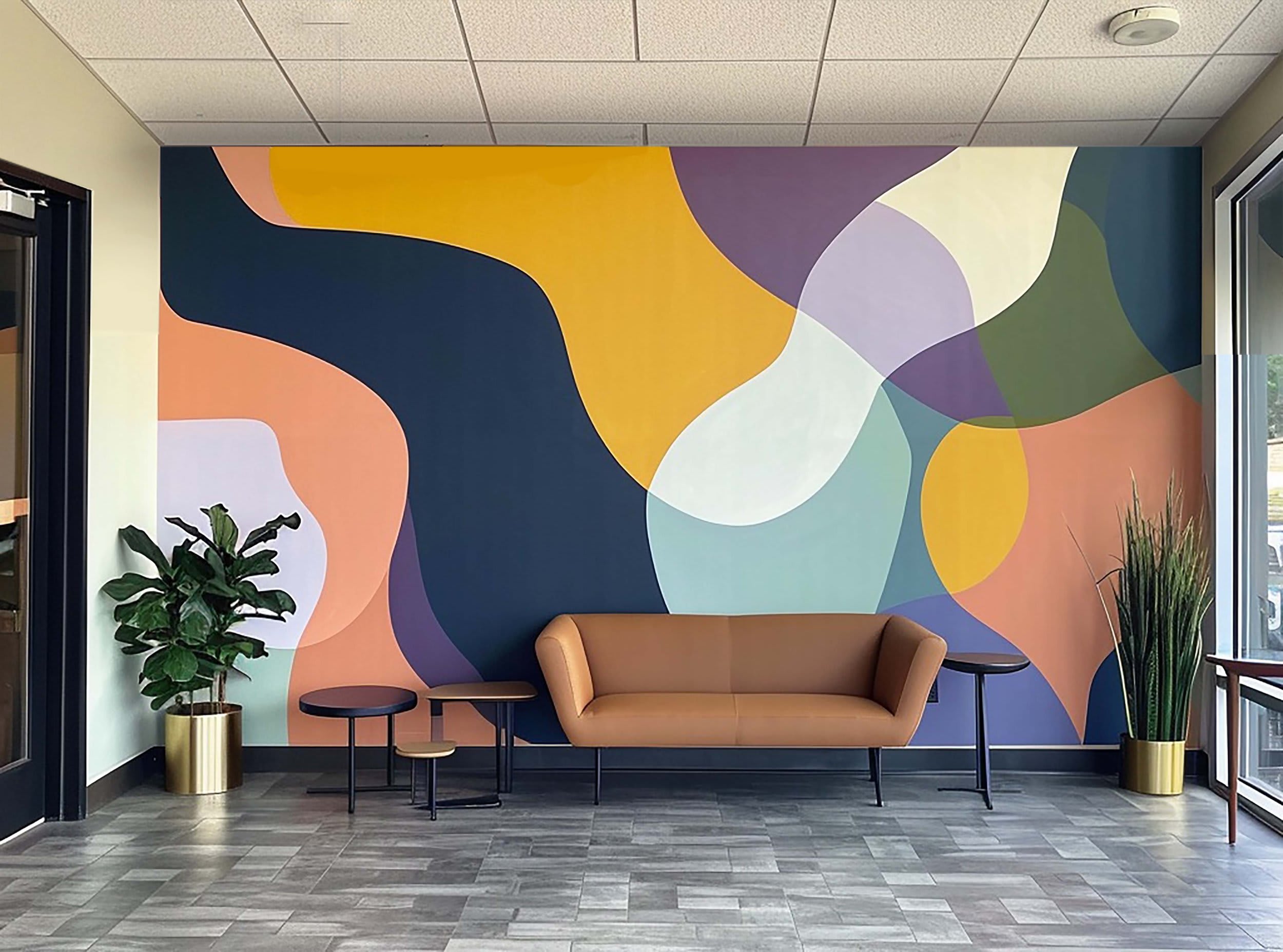 Artist painting a lobby mural for a Bay Area business