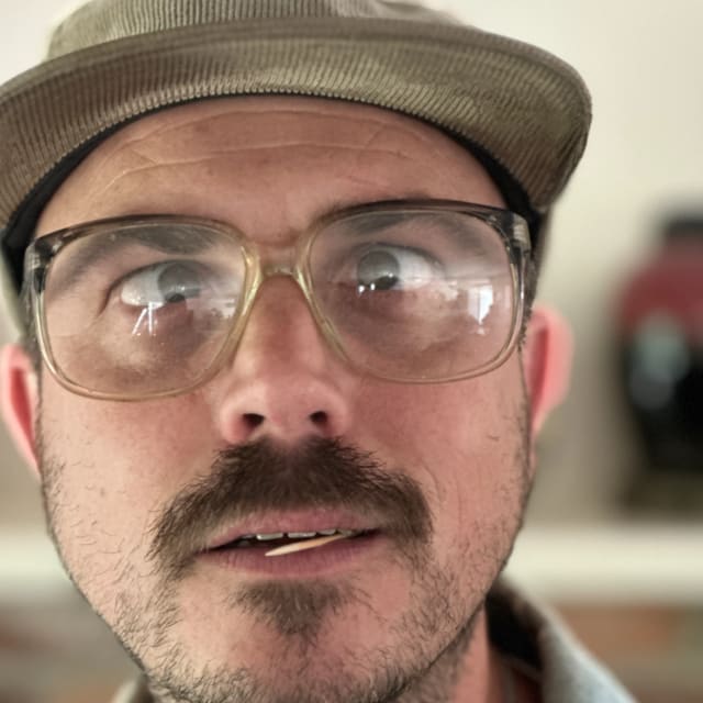 Close-up of a crew member wearing clear safety glasses at work in Sacramento