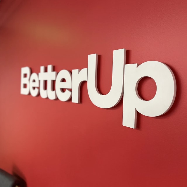 Angled close-up of BetterUp raised letters on a red wall for a Sacramento client