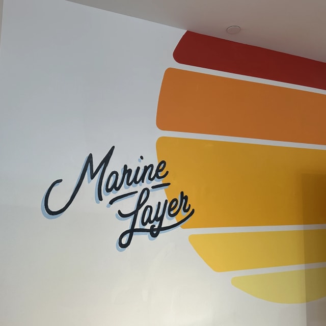 Marine Layer script lettering beside orange and yellow mural stripes in the Sacramento region