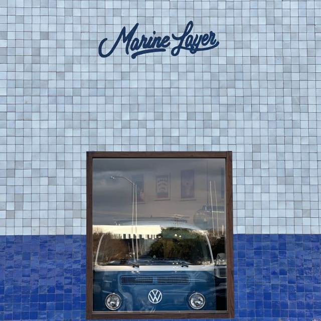 Marine Layer script sign above a window on a tiled facade in Sacramento