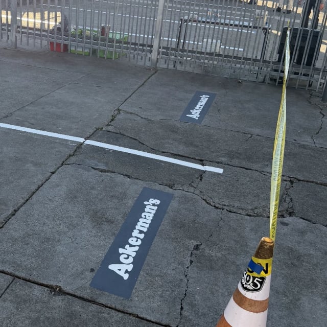 Ackerman’s lettering stenciled beside marked parking spaces