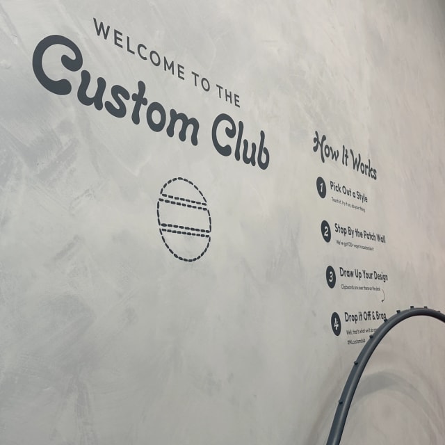 Welcome to the Custom Club lettering and values on an interior wall