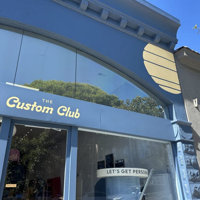 The Custom Club storefront lettering and window banner in the Sacramento region