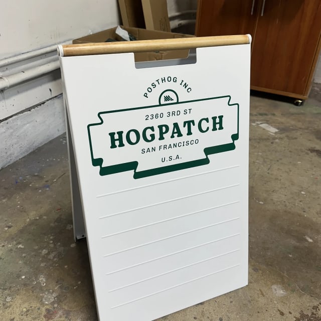 White Hogpatch A-frame sign with a green logo and changeable lettering area
