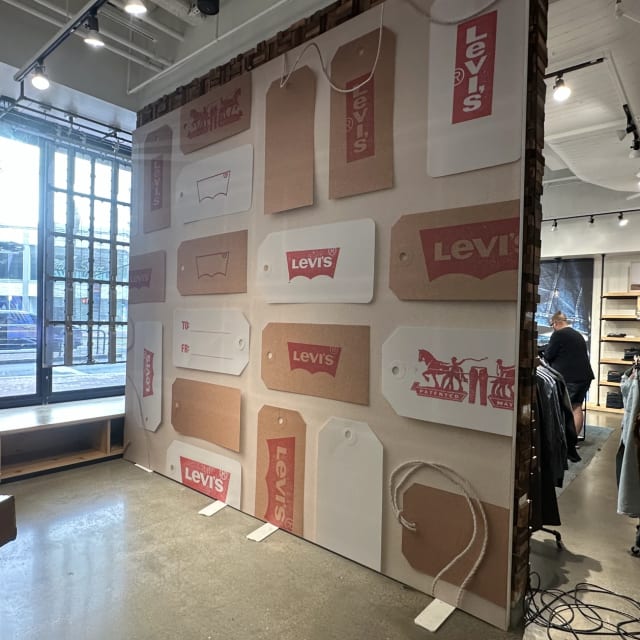 Retail wall graphic featuring a collage of Levi’s labels