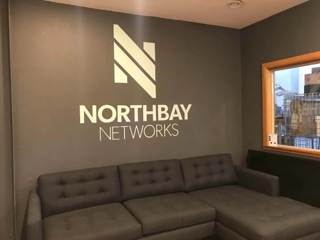 Northbay Networks logo above a gray office sofa