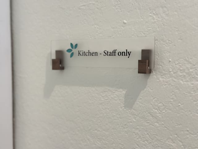 Frosted Kitchen - Staff only plaque mounted in wooden brackets in a Sacramento office
