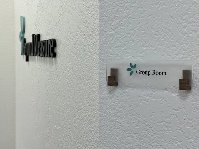 Group Room plaque beside a dimensional Beyond Measure wall logo for a Sacramento office