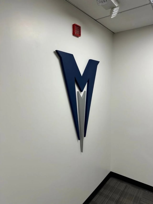 Menlo College dimensional M logo on a white interior wall