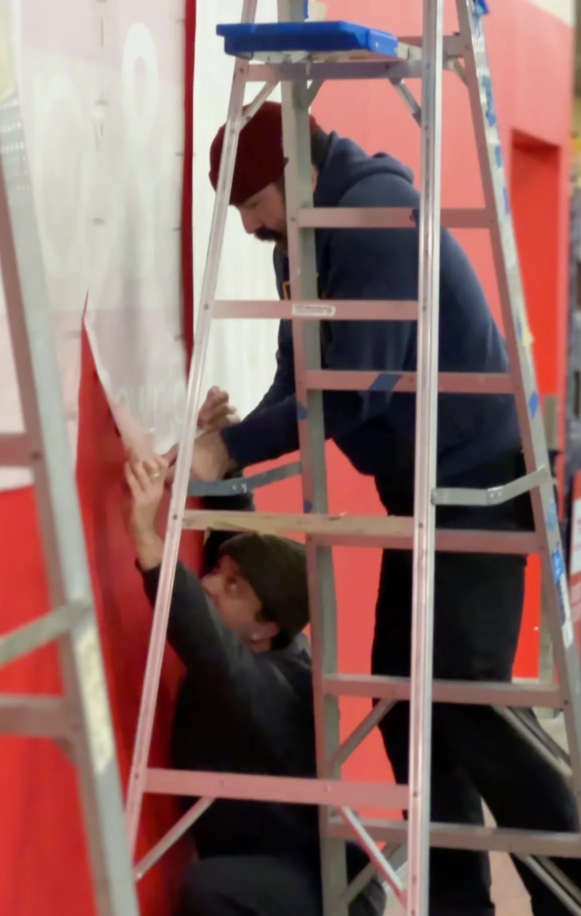 Installing Safeway vinyl wall graphics on a ladder