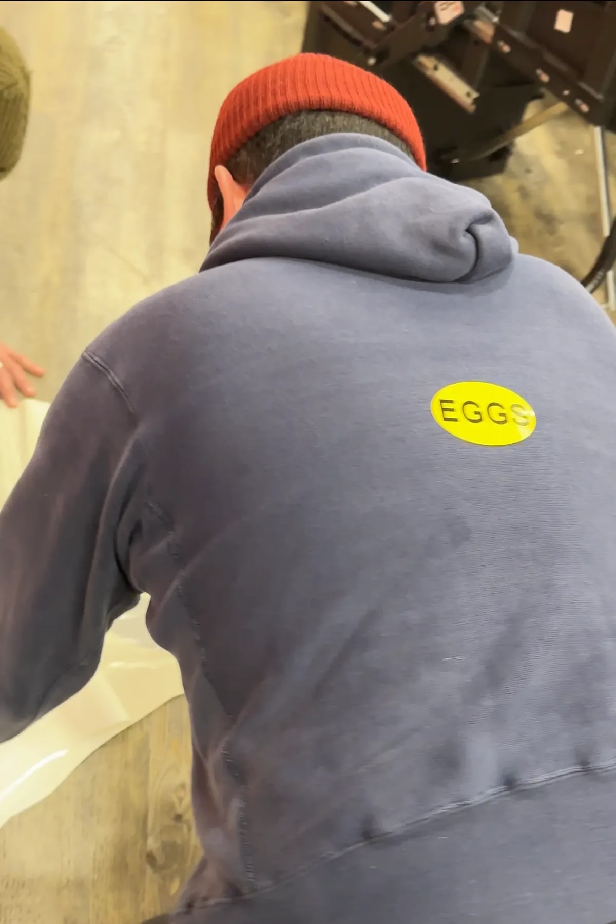 EGGS sticker on hoodie during Safeway vinyl installation