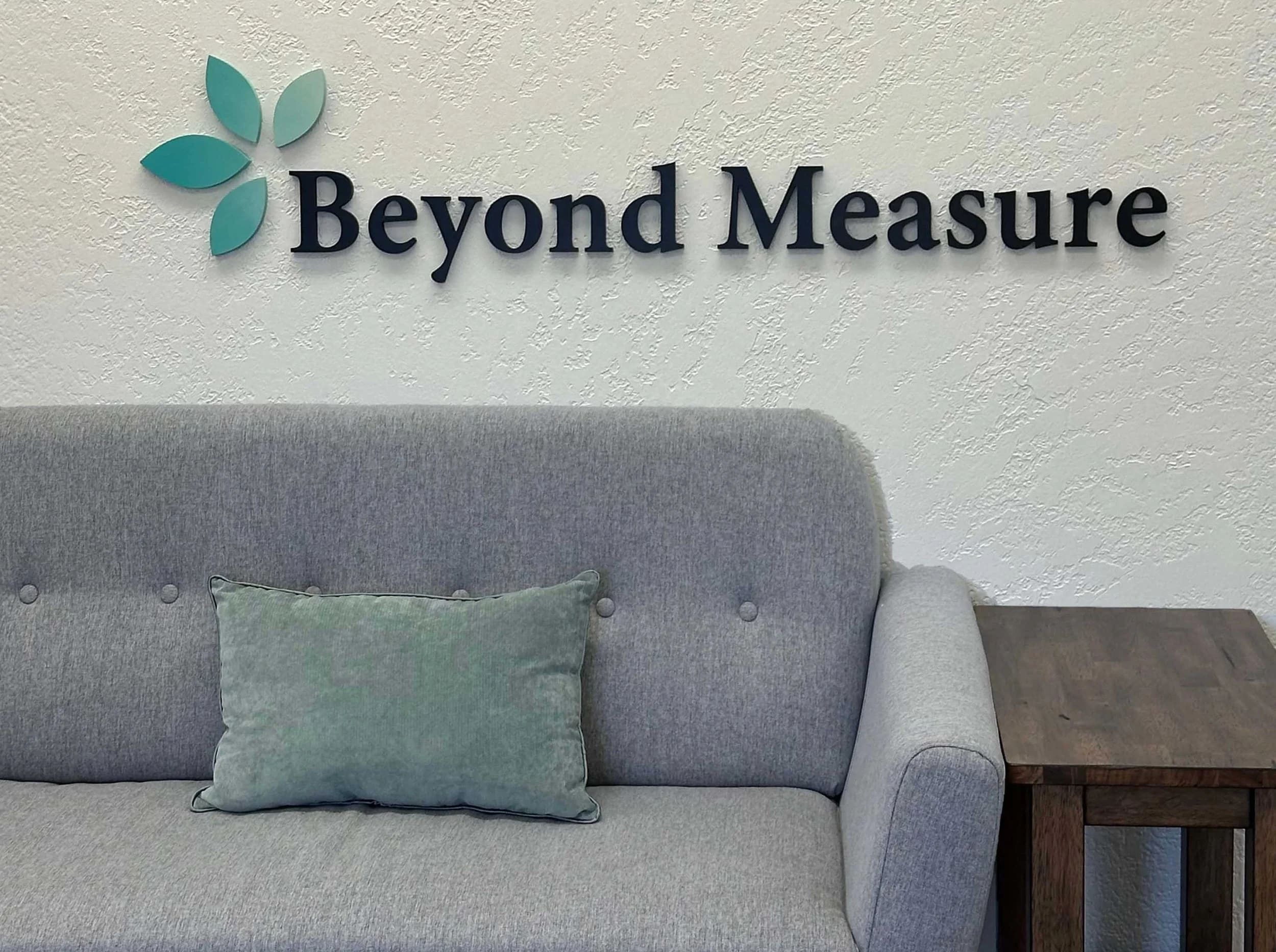 Custom-painted dimensional office logo mounted on a textured wall