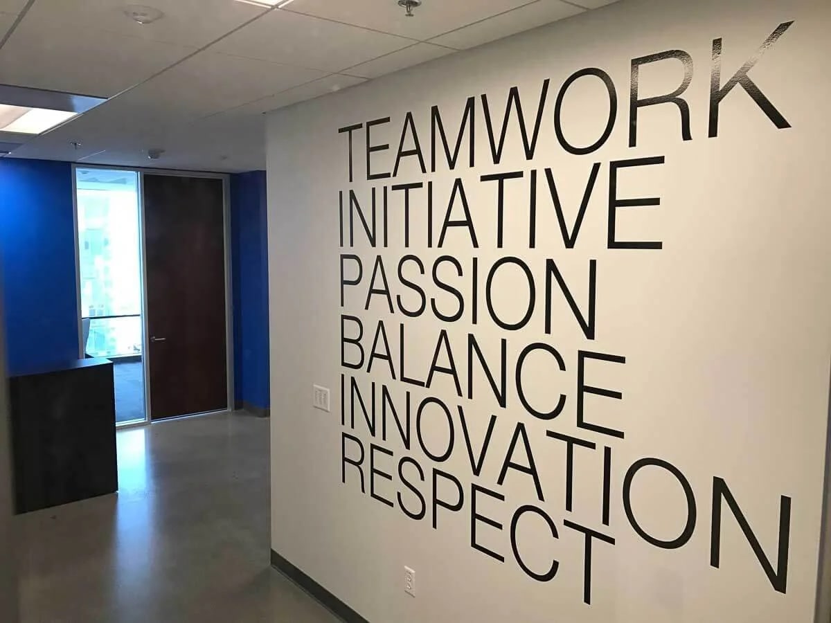 Finished black vinyl word wall in an office corridor