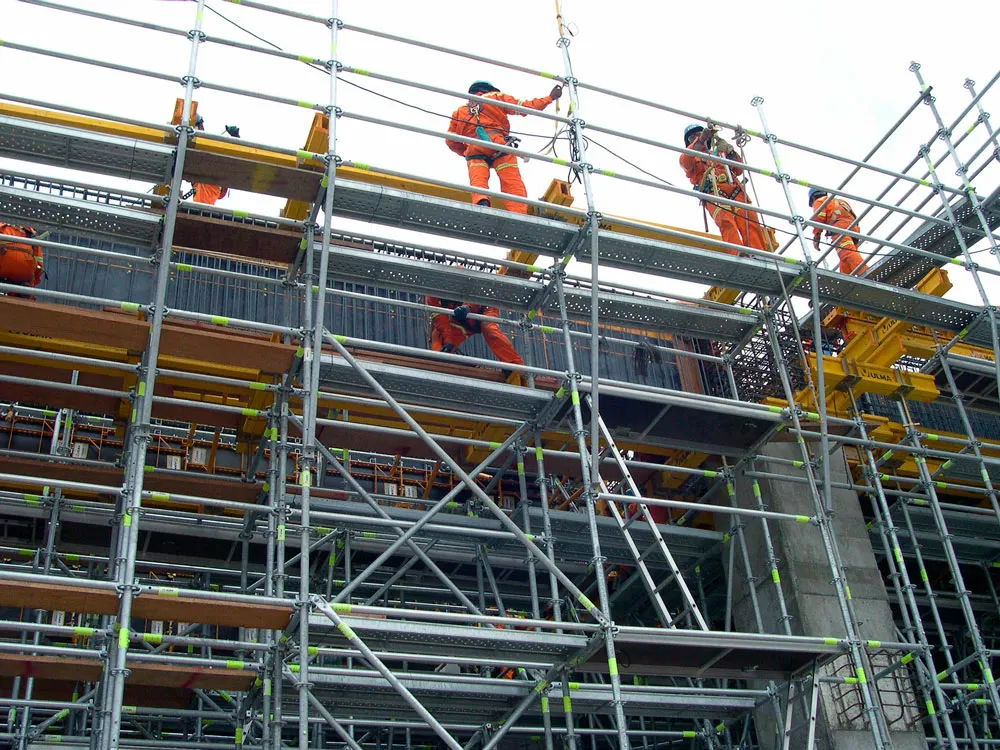 Obra de construcción civil en ejecución (estructura, andamios o maquinaria en sitio). Debe transmitir protección de obra bajo póliza CAR.