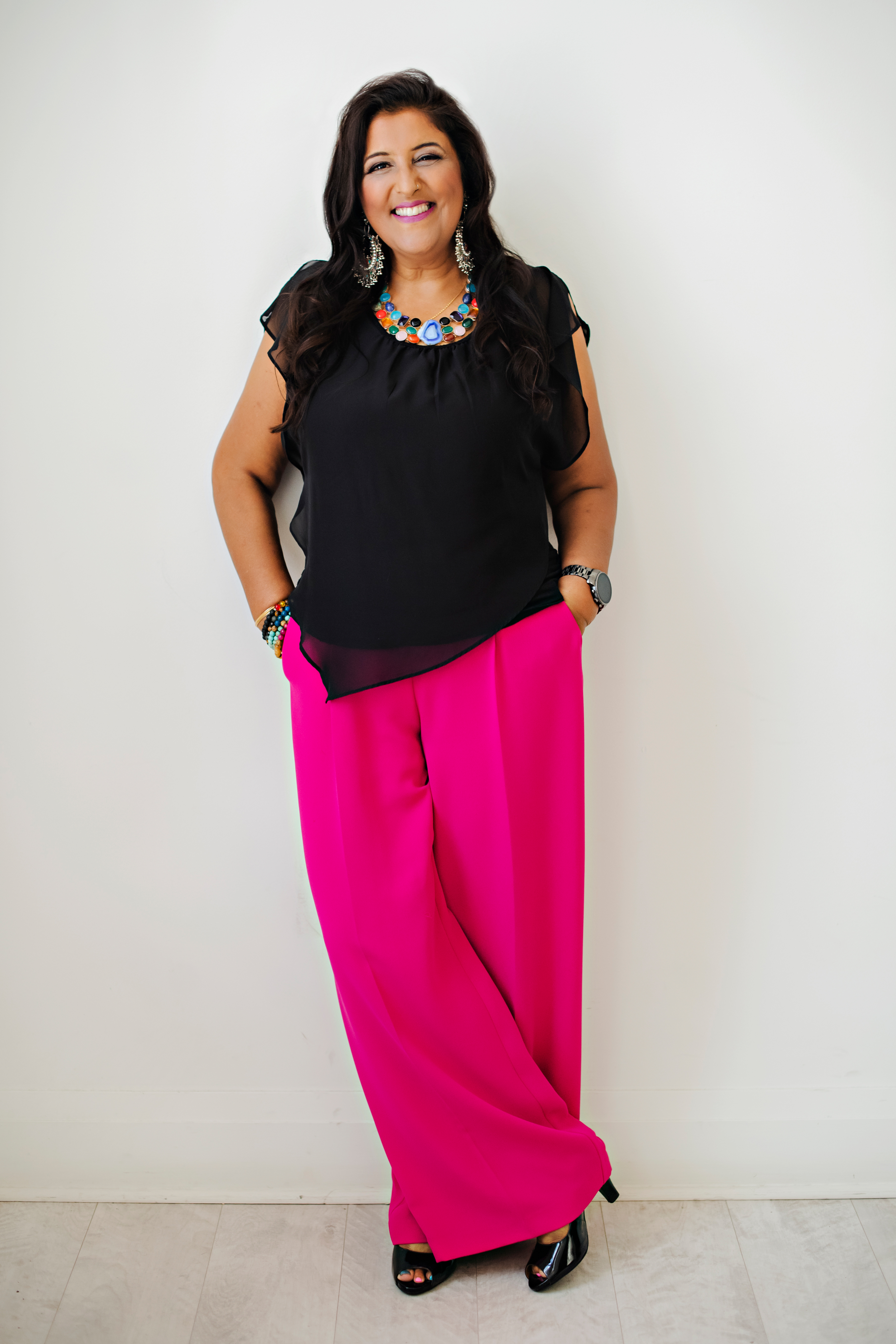 Bhupi Panesar in pink trousers against stone wall