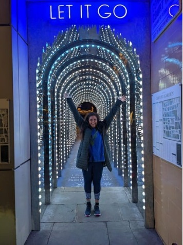 Bhupi Panesar arms raised under LET IT GO sign at Covent Garden