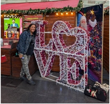 Bhupi Panesar standing next to LOVE sign