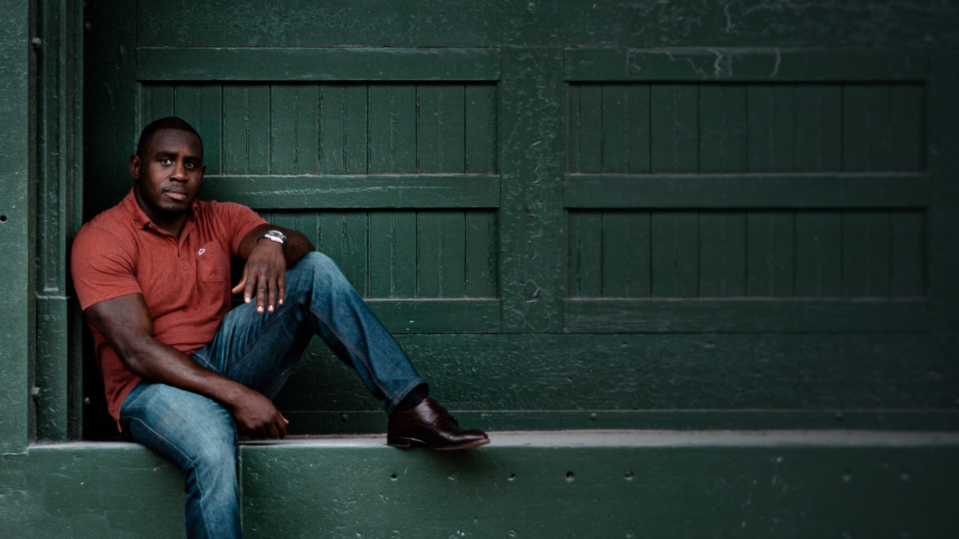 Ed Latimore sitting against a green door